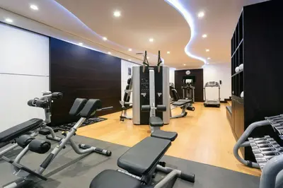a gym with several treadmills and cardio machines at Courtyard by Marriott Belgrade City Center in Belgrade