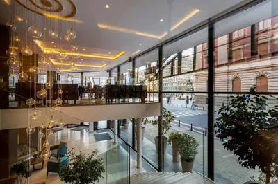 a view of the lobby of a building with large windows at Courtyard by Marriott Belgrade City Center in Belgrade