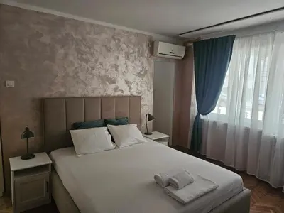 a bedroom with a bed with towels on it at Room Nine in Belgrade