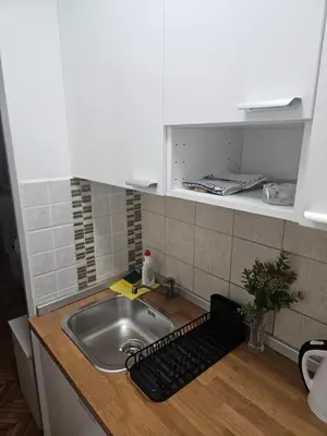 a kitchen counter with a sink and a keyboard at Room Nine in Belgrade