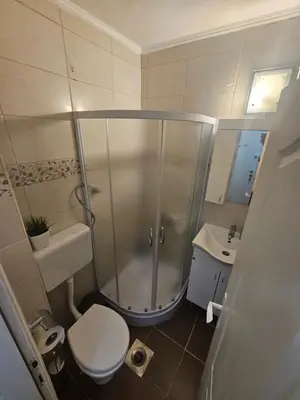 a bathroom with a shower and a toilet and a sink at Room Nine in Belgrade