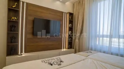a bedroom with a bed with a tv on the wall at Exclusive Apartment in Belgrade