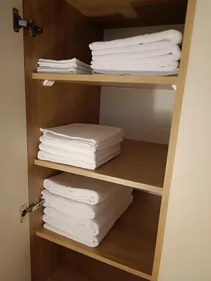 a stack of towels on a shelf in a bathroom at The Queen at Parkside in Belgrade