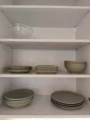 a kitchen with plates and bowls on shelves at The Queen at Parkside in Belgrade
