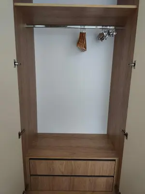 a closet with a wooden cabinet and a shelf at The Queen at Parkside in Belgrade