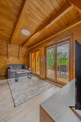 a living room with a couch and a table at Nektarija Pool House in Jankoviči