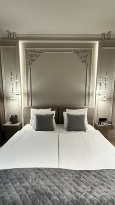 a large white bed with two pillows on it at DOM Boutique Apartments KING'S in Belgrade