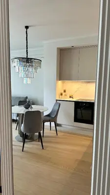 a dining room with a table and a chandelier at DOM Boutique Apartments KING'S in Belgrade