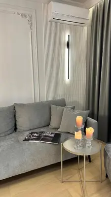 a living room with a couch and a table with candles at DOM Boutique Apartments KING'S in Belgrade