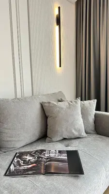 a magazine sitting on top of a couch at DOM Boutique Apartments KING'S in Belgrade