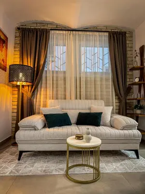 a living room with a couch and a table at Maison Dositej No20 in Belgrade