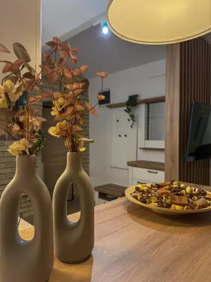 two vases on a table with a plate of food at Maison Dositej No20 in Belgrade