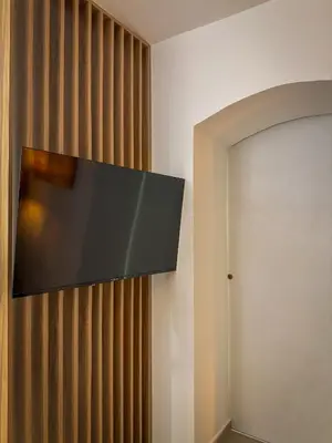 a flat screen tv hanging on a wall at Maison Dositej No20 in Belgrade