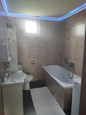 a bathroom with a tub and a toilet and a sink at Hit in Smederevo