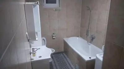 a bathroom with a toilet and a tub and a sink at Hit in Smederevo