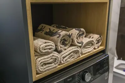 a bunch of towels on a shelf in a microwave at Apartment Cocosinella in Surčin