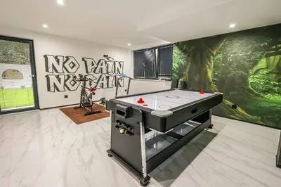 a ping pong table in a room with a mural at Apartment Cocosinella in Surčin