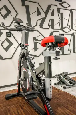 a bike with a red seat in front of a wall at Apartment Cocosinella in Surčin