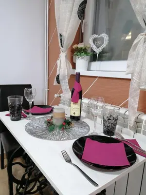 a white table with a bottle of wine on it at DEP House in Beograd