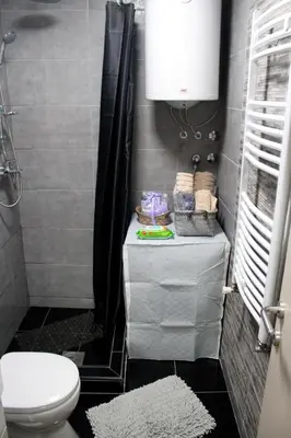 a small bathroom with a toilet and a sink at DEP House in Beograd