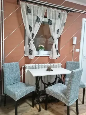 a table and two chairs with a window at DEP House in Beograd