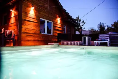 a house with a swimming pool in front of a house at Kuca na dan - DIKAN in Ba°evac