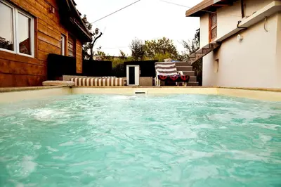 a swimming pool in front of a house at Kuca na dan - DIKAN in Ba°evac