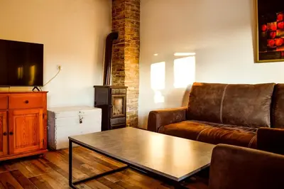 a living room with a couch and a coffee table at Kuca na dan - DIKAN in Ba°evac