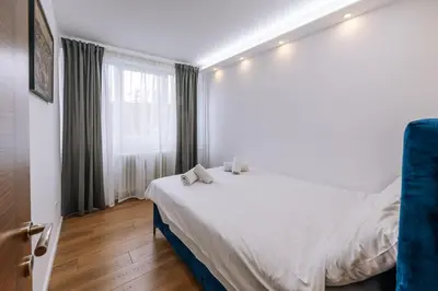 a bedroom with a white bed and a window at Marshal Autokomanda in Belgrade
