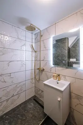 a white bathroom with a sink and a mirror at Marshal Autokomanda in Belgrade