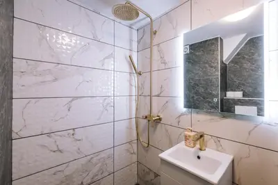 a white bathroom with a sink and a mirror at Marshal Autokomanda in Belgrade