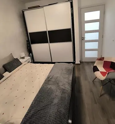 a bedroom with a bed and a large sliding door at Nina Urban Apartment-Novi Beograd in Belgrade