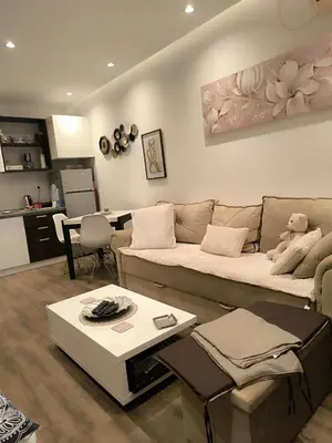 a living room with a couch and a table at Nina Urban Apartment-Novi Beograd in Belgrade