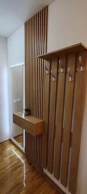 a bathroom with a wooden shelf and a mirror at Royal lux apartman Beograd in Belgrade