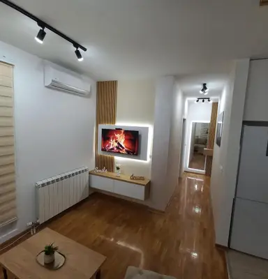 a living room with a fireplace in the wall at Royal lux apartman Beograd in Belgrade
