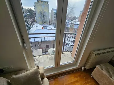 a room with a window with a view of a balcony at Royal lux apartman Beograd in Belgrade
