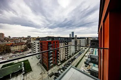 a view of a city from a balcony of a building at ZIGZAG Belgrade Waterfront King in Belgrade