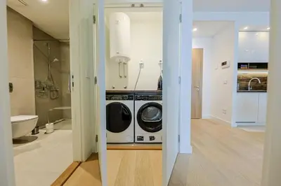 a kitchen with a washer and dryer in a bathroom at ZIGZAG Belgrade Waterfront King in Belgrade