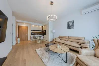 a living room with a couch and a table at ZIGZAG Belgrade Waterfront King in Belgrade