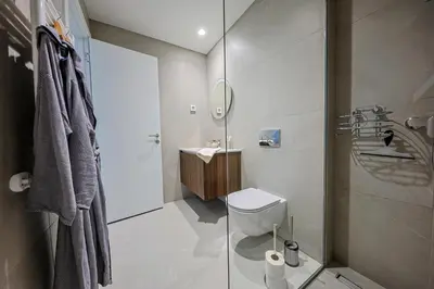 a bathroom with a toilet and a sink and a shower at ZIGZAG Belgrade Waterfront King in Belgrade