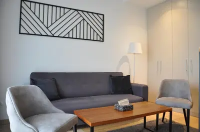 a living room with a couch and two chairs and a table at BW Studio Oasis! Garage, Terrace, Kula&Galerija! in Belgrade