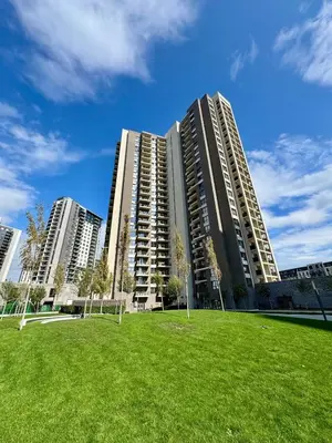 a large apartment building with a grass field in front at BW Studio Oasis! Garage, Terrace, Kula&Galerija! in Belgrade
