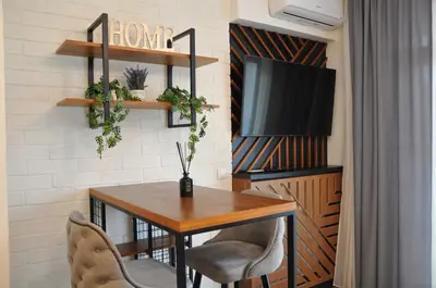 a dining room with a table and a tv at BW Studio Oasis! Garage, Terrace, Kula&Galerija! in Belgrade