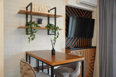 a dining room with a table and a tv at BW Studio Oasis! Garage, Terrace, Kula&Galerija! in Belgrade