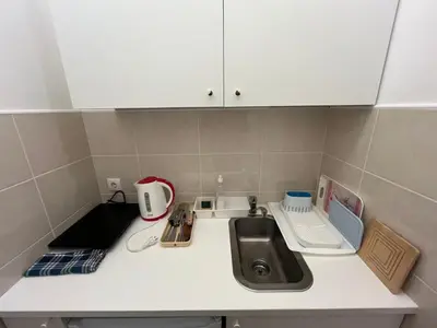 a small kitchen with a sink and a counter top at Heart Studio in Belgrade