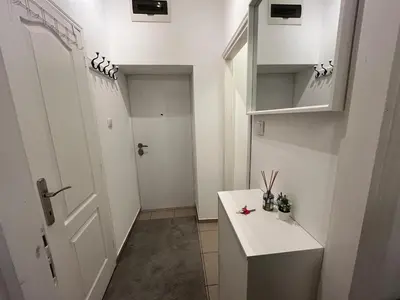 a small kitchen with a white door and a white counter at Heart Studio in Belgrade