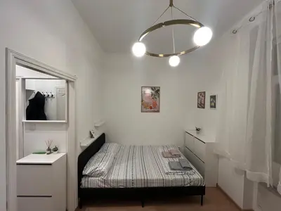 a small bedroom with a bed and a mirror at Heart Studio in Belgrade