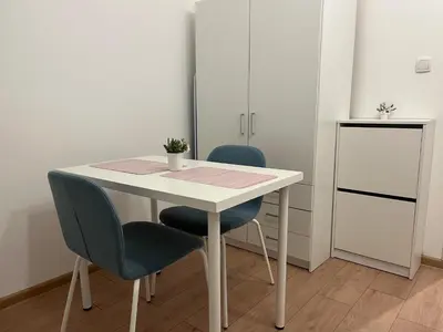 a white table and two chairs in a room at Heart Studio in Belgrade