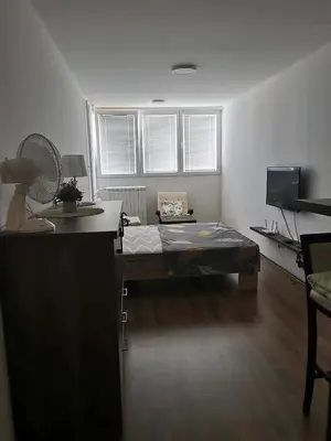 a room with a bed in the middle of a room at Andrej 62 in Beograd