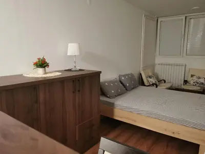 a small room with a bed and a couch at Andrej 62 in Beograd